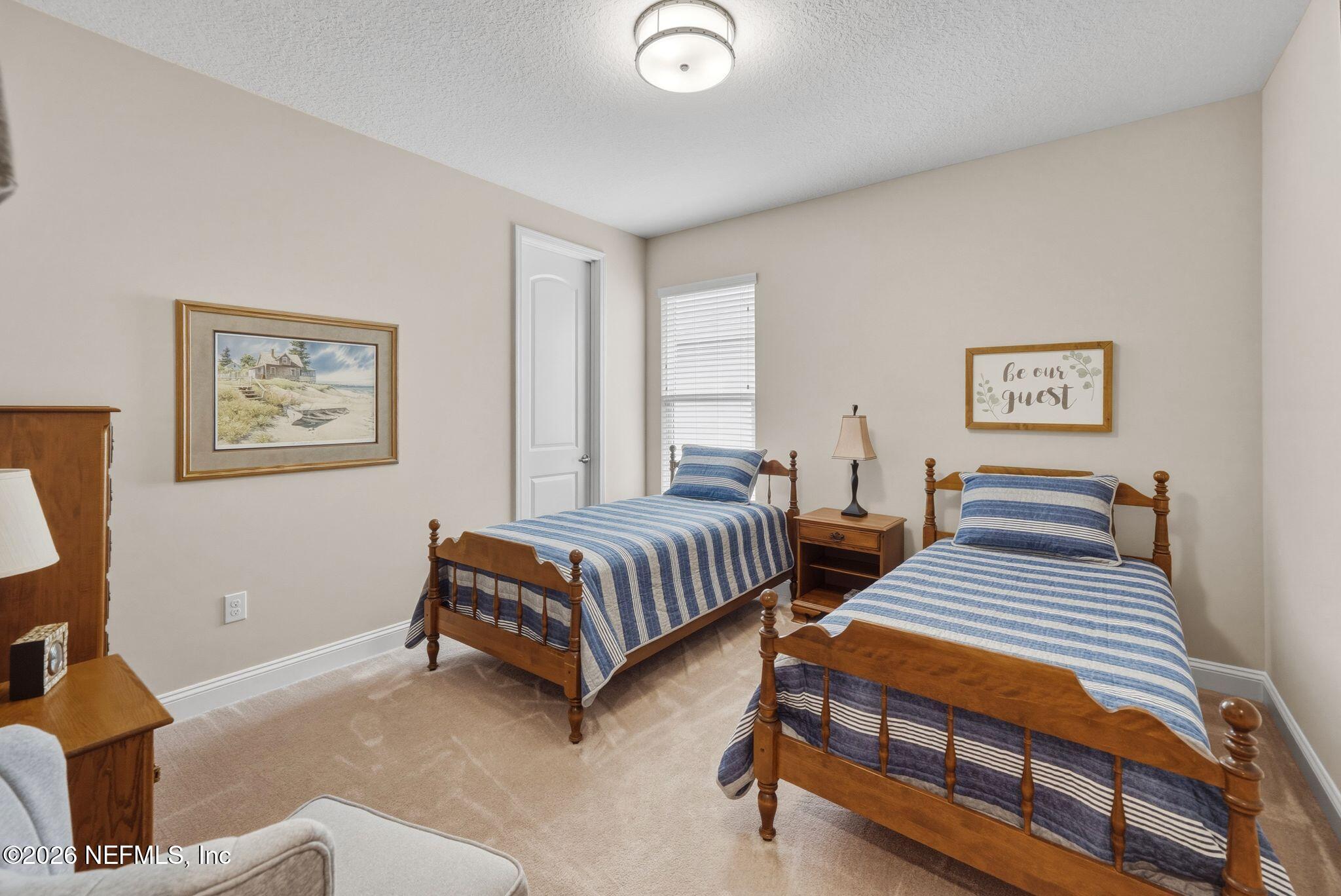 334 Athens Drive St. Augustine, FL 32092 - Photo 28 of 57 a bedroom with two beds and painting on the wall