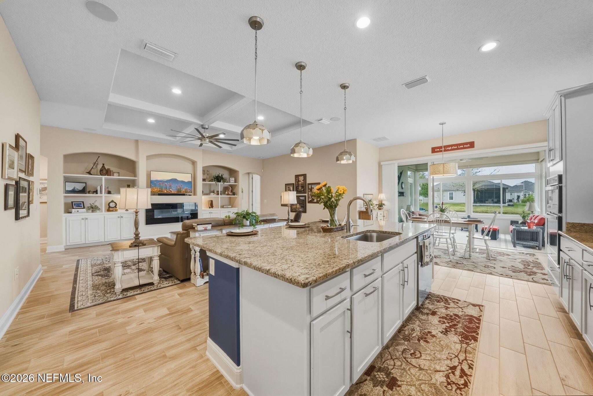 334 Athens Drive St. Augustine, FL 32092 - Photo 5 of 57 a large kitchen with stainless steel appliances kitchen island granite countertop a large counter top and view of living room