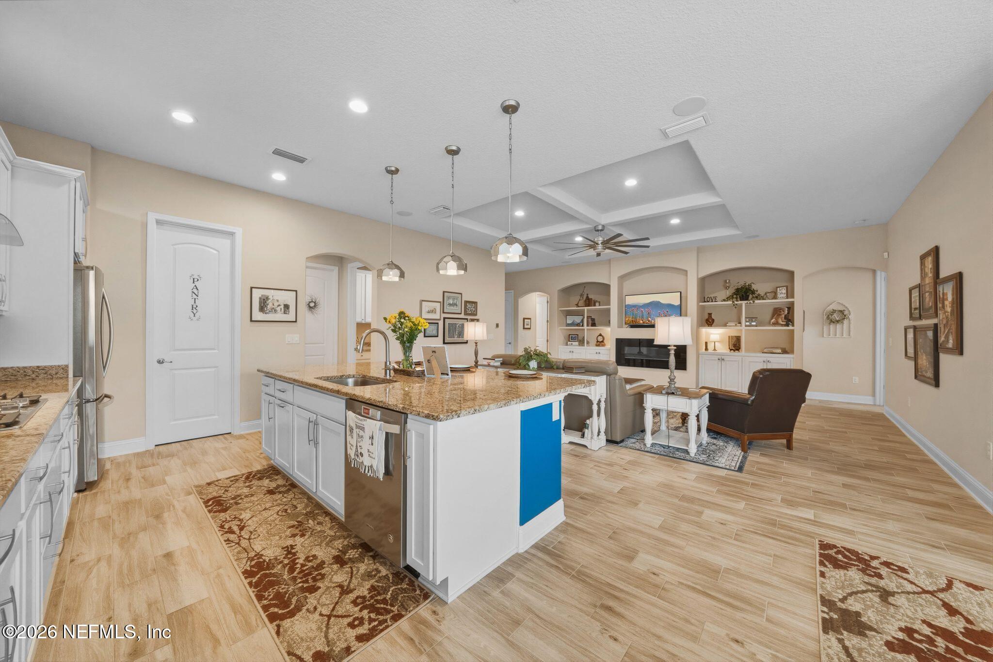 334 Athens Drive St. Augustine, FL 32092 - Photo 6 of 57 a large kitchen with stainless steel appliances kitchen island granite countertop a large counter top and wooden floors