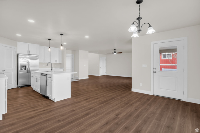 578 West 7th Midvale, UT 84047 - Photo 34 of 35 Kitchen featuring ceiling fan, stainless steel appliances, open floor plan, dark wood-type flooring, and white cabinets