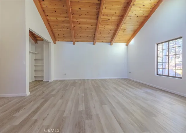 an empty room with wooden floor