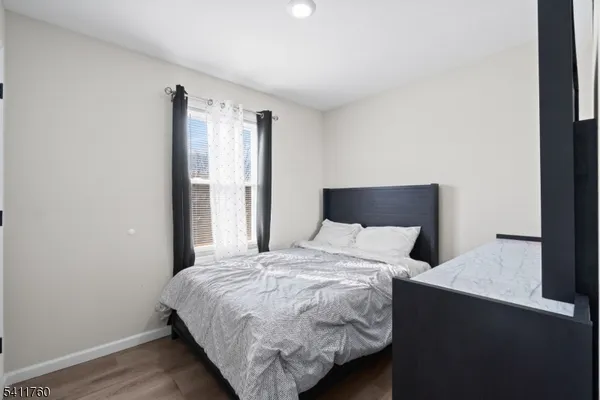 a bedroom with a bed and a night stand