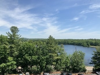 1550 Worcester Road, Unit 414B Framingham, MA 01702 - Photo 1 of 8 a view of a lake with houses in the back