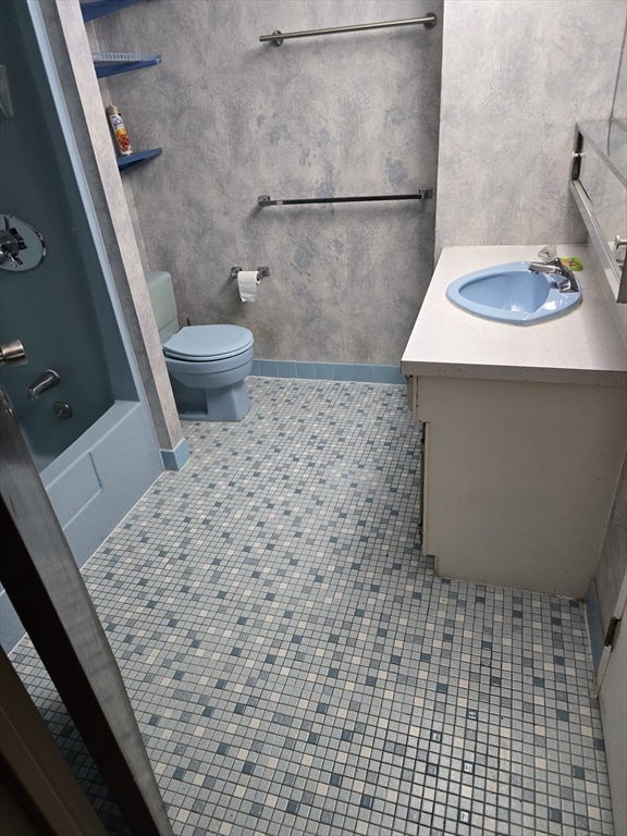 1550 Worcester Road, Unit 414B Framingham, MA 01702 - Photo 6 of 8 a bathroom with a sink and a toilet