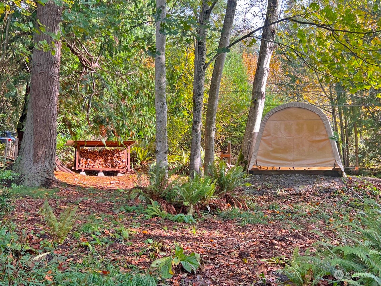 a backyard of a house with table and chairs