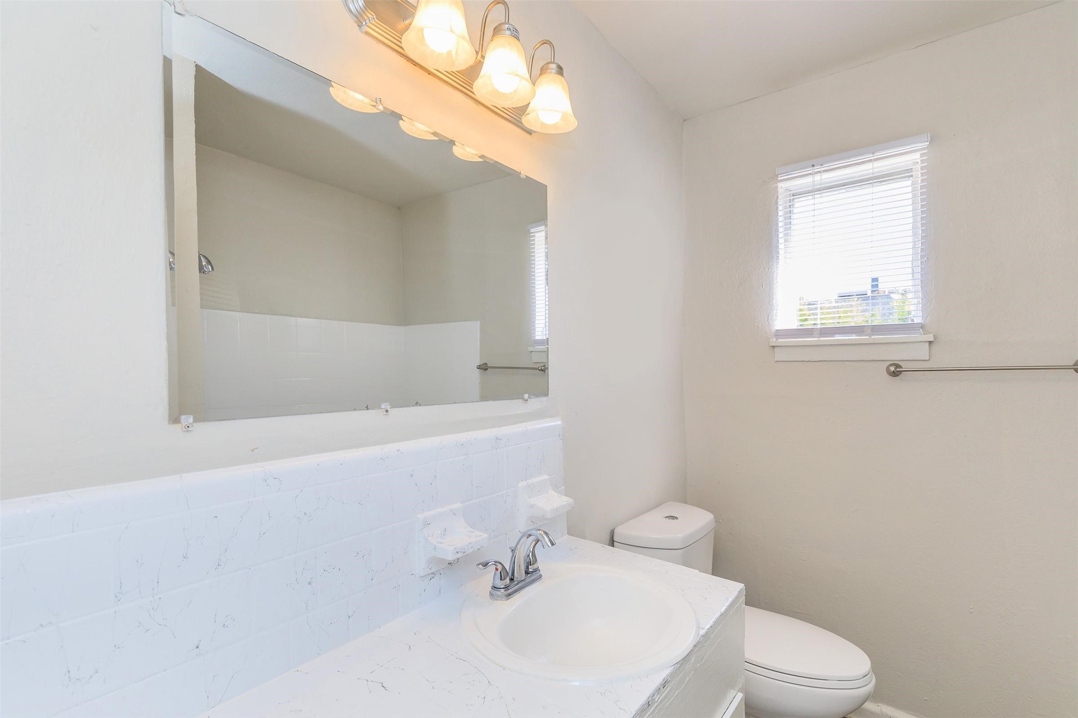8271 Stone Street, Unit 7509 Houston, TX 77061 - Photo 6 of 21 a white toilet sitting next to a bathroom sink