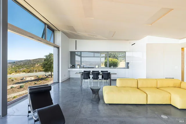 a large white kitchen with a large window