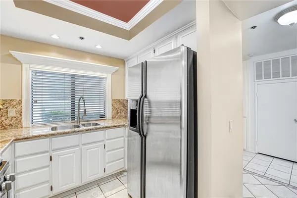a kitchen with stainless steel appliances granite countertop a refrigerator and a sink