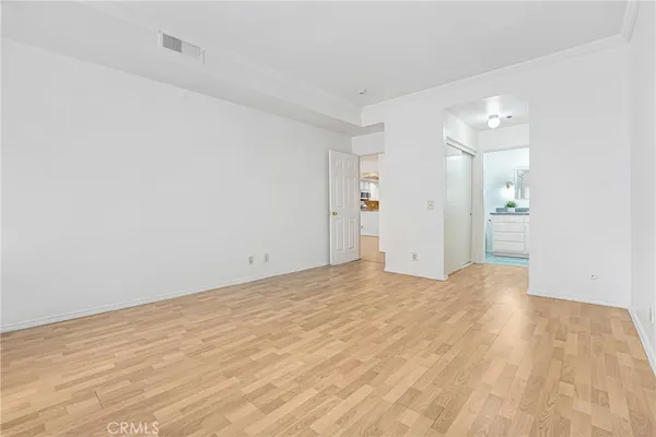 a view of empty room with wooden floor