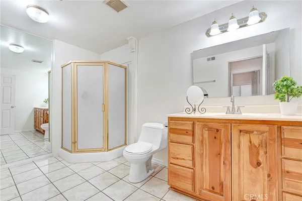 a spacious bathroom with a granite countertop sink and a mirror