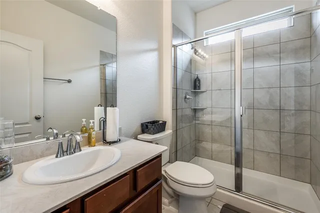 a bathroom with a sink toilet and shower