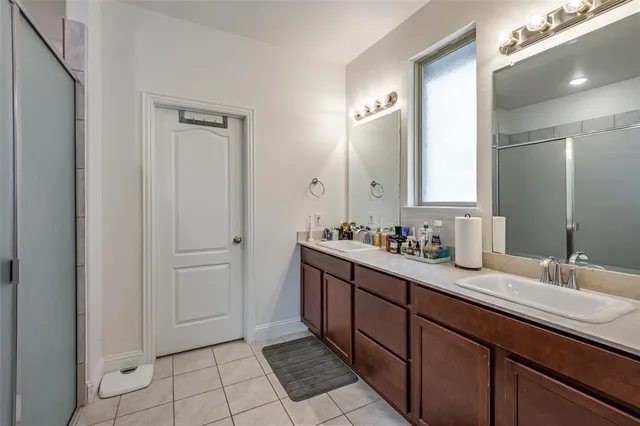 a bathroom with a double vanity sink and mirror