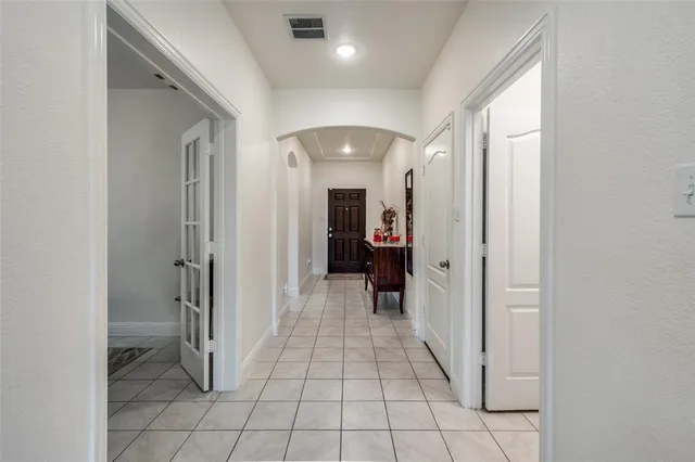 a view of a hallway with wooden shelves