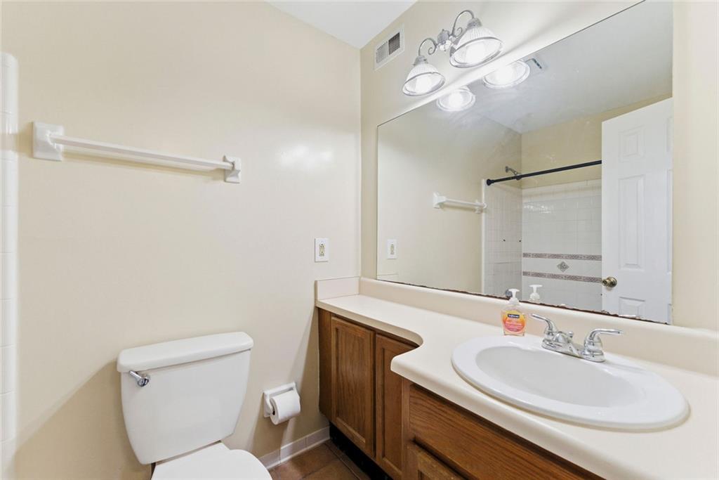 2043 Brian Way Decatur, GA 30033 - Photo 16 of 25 a bathroom with a toilet sink and mirror