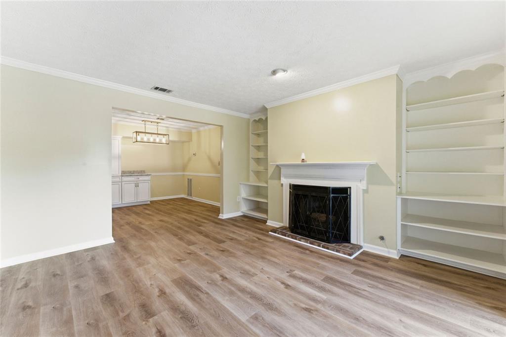 2043 Brian Way Decatur, GA 30033 - Photo 2 of 25 a view of empty room with wooden floor and fireplace