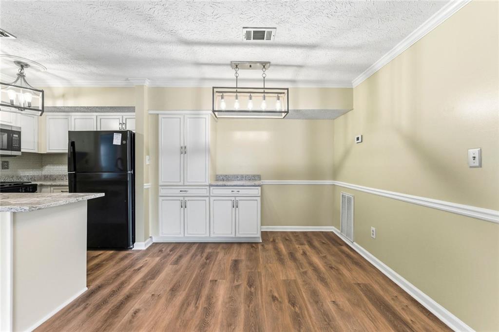 2043 Brian Way Decatur, GA 30033 - Photo 6 of 25 a kitchen with a refrigerator and countertop white cabinets