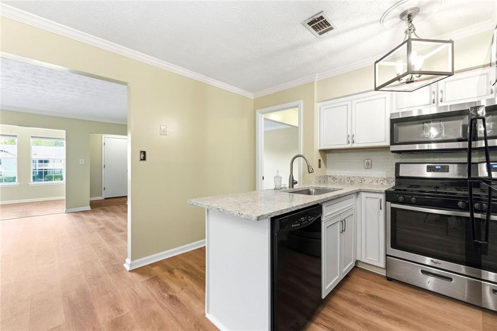 2043 Brian Way Decatur, GA 30033 - Photo 10 of 25 a kitchen with stainless steel appliances granite countertop a sink and a stove