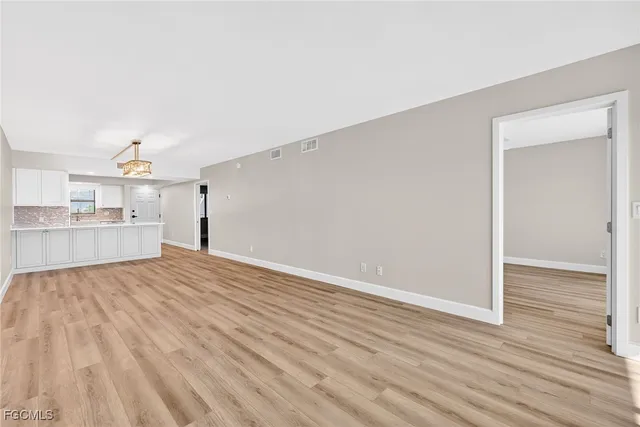 a view of a kitchen with wooden floor and a sink