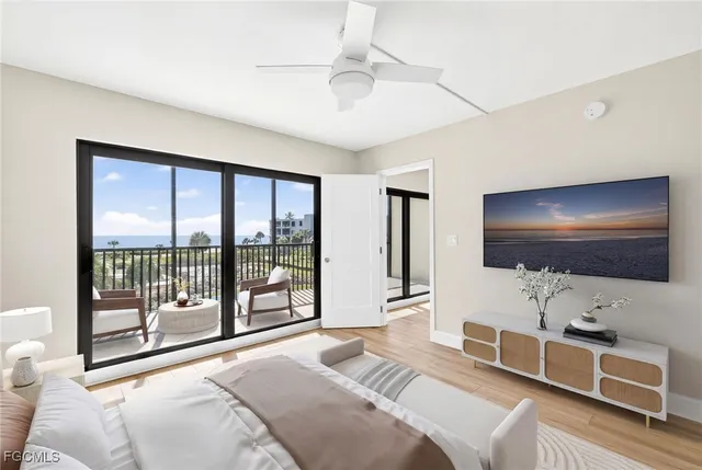a bedroom with furniture and a flat screen tv