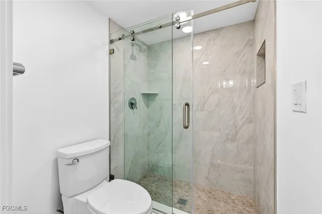 a white toilet sitting next to a bathroom sink