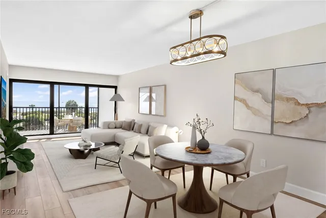 a living room with furniture a chandelier and a large window