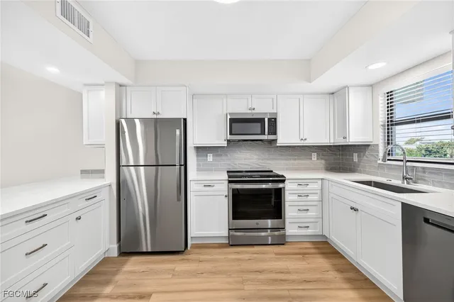 a kitchen with a refrigerator stove and sink