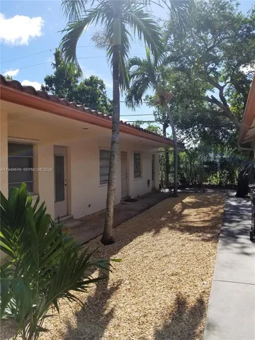 a view of a backyard with a tree