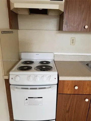 a kitchen with a sink a stove and a refrigerator