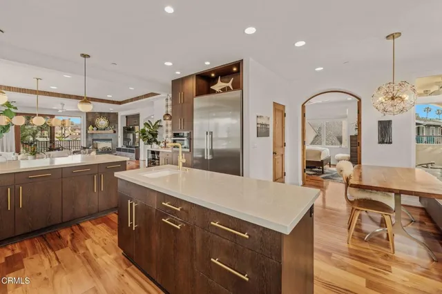 a large kitchen with a table and chairs