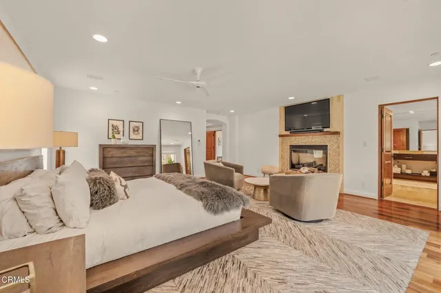 a bedroom with a bed and a dresser next to a window