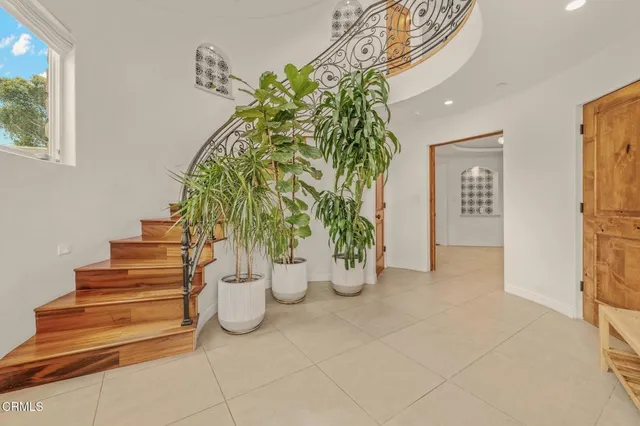 a living room with furniture and a floor to ceiling window