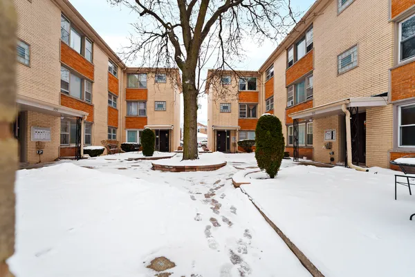 a view of a building with snow on the road