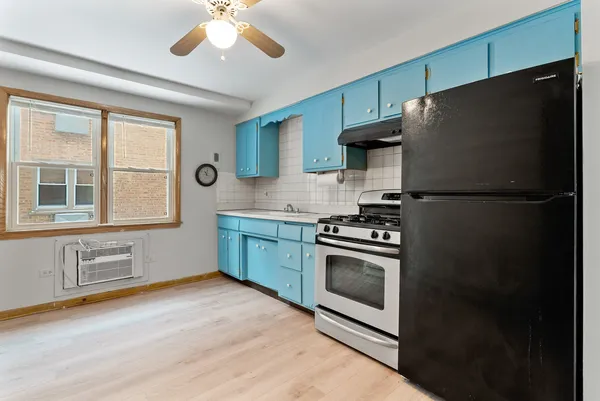 a kitchen with stainless steel appliances a refrigerator stove and sink