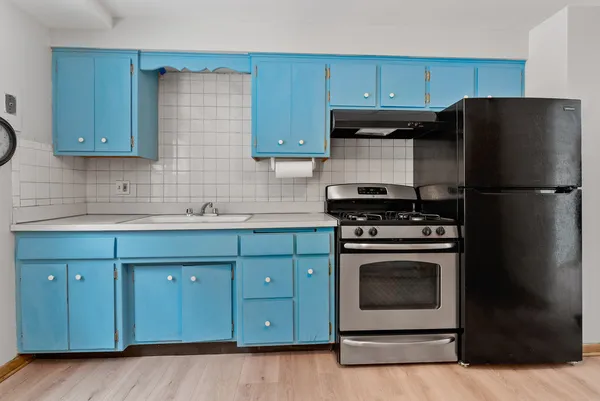 a kitchen with stainless steel appliances granite countertop a stove a refrigerator and a cabinets