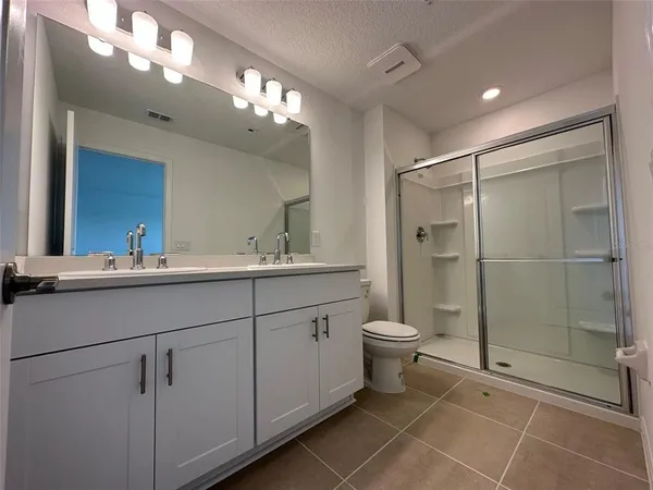 a bathroom with a toilet sink and shower