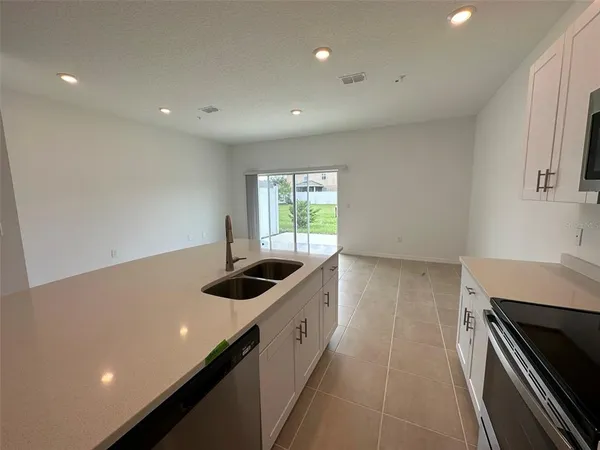 a kitchen with a sink and stove top oven