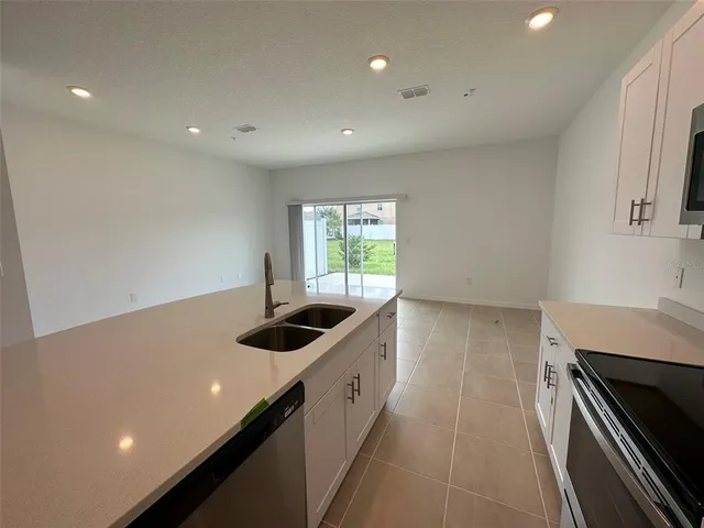 a kitchen with a sink and stove top oven
