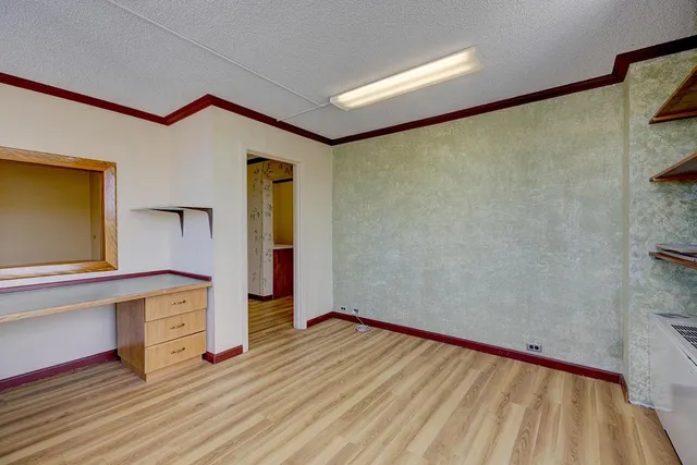 a view of a room with wooden floor and furniture