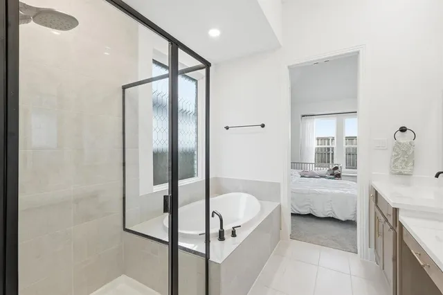 a bathroom with a tub sink and mirror