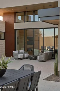 a view of a roof deck with table and chairs with wooden floor and fence