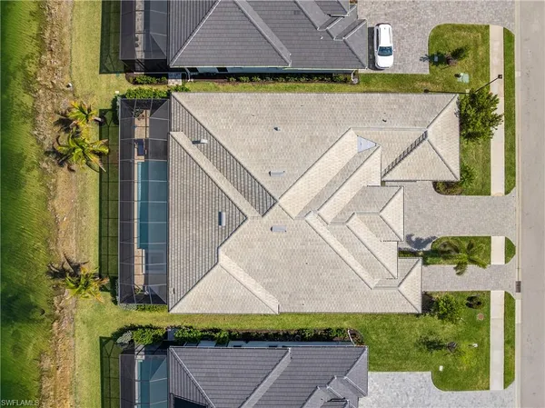 an aerial view of residential houses with yard and ocean view