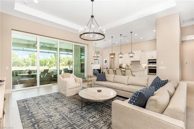 a living room with furniture wooden floor and a chandelier