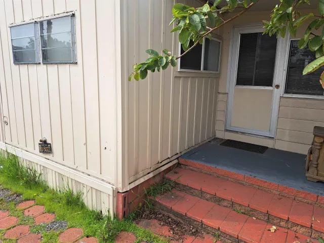 a view of a house with a small yard