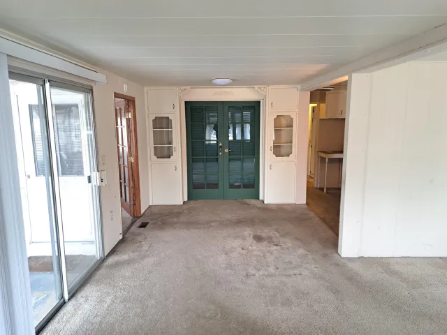 a view of an empty room with entrance and door