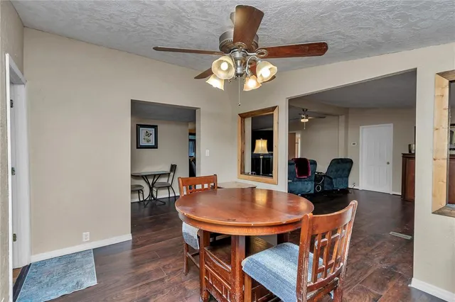 a dining room with furniture and wooden floor