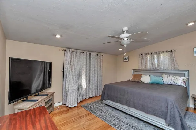 a bedroom with a bed and a flat screen tv