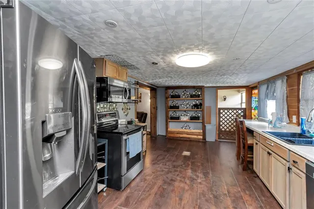 a kitchen with stainless steel appliances a sink stove and window