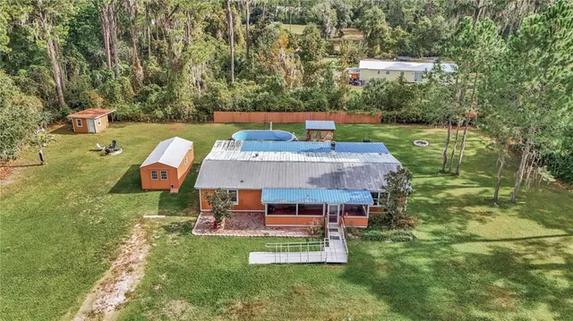 an aerial view of a house with a big yard