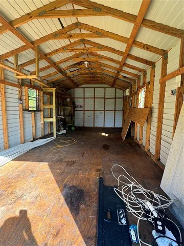 a backyard of a house with barbeque oven and outdoor seating