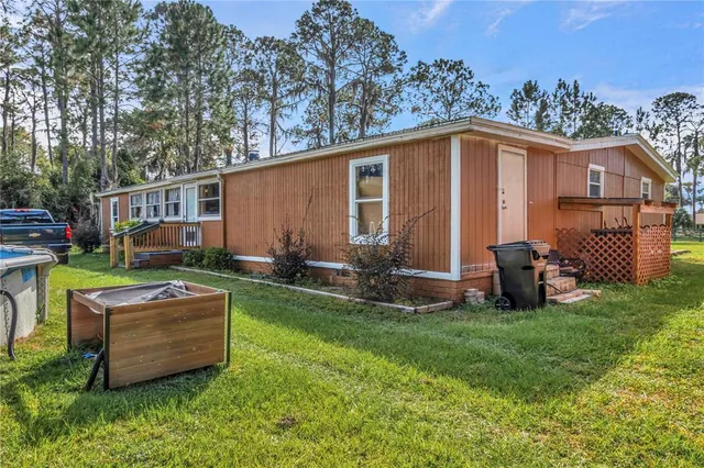 a view of a house with a backyard